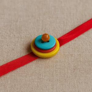 Handmade button rakhi with colorful stacked buttons for Rakhi 2025